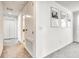Hallway with carpet flooring, white walls, artwork and access to bedrooms and bathrooms at 111 Rain Lily Ave, Spring Hill, FL 34609