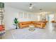 Bright living room with a leather sectional sofa, ceiling fan, and modern décor at 111 Rain Lily Ave, Spring Hill, FL 34609