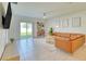 Comfortable living room featuring a sliding glass door to the backyard and a cozy seating arrangement at 111 Rain Lily Ave, Spring Hill, FL 34609