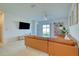 Spacious living room with access to backyard, comfortable seating and entertainment area at 111 Rain Lily Ave, Spring Hill, FL 34609