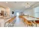 Open concept with kitchen island, dining area with a marble table, and living room in the background at 111 Rain Lily Ave, Spring Hill, FL 34609