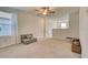 Bright loft area featuring a ceiling fan, neutral walls, and plush carpeting at 111 Rain Lily Ave, Spring Hill, FL 34609
