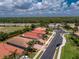 Aerial view of home with well-maintained landscaping and tile roof within a quiet neighborhood at 11666 Parrotfish St, Venice, FL 34292