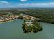 Scenic aerial view of a community nestled on the water with a pool and lush green landscaping at 11666 Parrotfish St, Venice, FL 34292