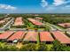 Aerial view highlighting this home’s tile roof and landscaping amidst a serene, well-kept neighborhood at 11666 Parrotfish St, Venice, FL 34292