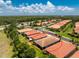 Aerial view of the property showcasing its tile roof and manicured landscaping within a quiet community at 11666 Parrotfish St, Venice, FL 34292