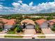 Aerial view of one-story home featuring a brick driveway, two-car garage and lush landscaping at 11666 Parrotfish St, Venice, FL 34292