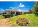 Manicured backyard featuring lush lawn, mature trees, and well-maintained landscaping at 11666 Parrotfish St, Venice, FL 34292