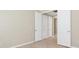 This bedroom has beige walls, tile flooring, white trim, and several doors that are white at 11666 Parrotfish St, Venice, FL 34292