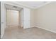 This bedroom has beige walls, tile flooring, a white door, and white trim around the ceiling at 11666 Parrotfish St, Venice, FL 34292