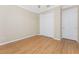 Bedroom features a ceiling fan, wood-look floors, window with blinds, closet and a white door at 11666 Parrotfish St, Venice, FL 34292