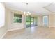Bright dining room with sliding glass doors and a modern chandelier at 11666 Parrotfish St, Venice, FL 34292