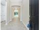 Entryway with view into open-concept living space with tiled floor, archways, and tray ceilings at 11666 Parrotfish St, Venice, FL 34292