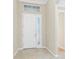 Entryway with white front door, tile floors, and transom window above door at 11666 Parrotfish St, Venice, FL 34292