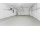 Spacious garage with epoxy flooring, storage shelving and automatic door at 11666 Parrotfish St, Venice, FL 34292
