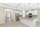 Bright kitchen with white cabinets, stainless steel appliances, and a large granite island at 11666 Parrotfish St, Venice, FL 34292