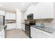 Kitchen featuring white cabinets, stainless steel appliances, and tiled backsplash at 11666 Parrotfish St, Venice, FL 34292
