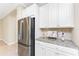 Close-up of kitchen showcasing stainless steel refrigerator and granite countertops with backsplash at 11666 Parrotfish St, Venice, FL 34292