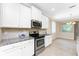 Modern kitchen featuring stainless steel appliances, granite countertops, and ample cabinet space at 11666 Parrotfish St, Venice, FL 34292