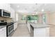 Spacious kitchen with stainless steel appliances, granite counters, and access to the outdoor space at 11666 Parrotfish St, Venice, FL 34292