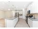 Well-lit kitchen with white cabinets, stainless steel appliances, and a granite-topped island at 11666 Parrotfish St, Venice, FL 34292