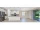 Kitchen featuring white cabinets, stainless steel appliances, granite island, and sliding glass doors at 11666 Parrotfish St, Venice, FL 34292