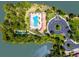 Spectacular aerial view showcases a beautiful resort-style pool and clubhouse surrounded by lush landscaping and serene lake views at 11666 Parrotfish St, Venice, FL 34292