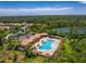 A great aerial view of a community pool, clubhouse, parking, and green landscaping near residential houses at 11666 Parrotfish St, Venice, FL 34292