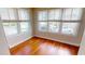 Cozy bedroom showcasing wood floors and natural light streaming through large windows at 1250 Lemon St, Punta Gorda, FL 33950