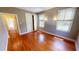 Bright bedroom featuring hardwood floors, a closet, and sunlit windows with blinds at 1250 Lemon St, Punta Gorda, FL 33950