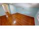 Bedroom featuring light blue walls, hardwood floors, and natural light through the window at 1250 Lemon St, Punta Gorda, FL 33950