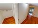 Hallway featuring hardwood floors, closet space, leading to another room with bright light at 1250 Lemon St, Punta Gorda, FL 33950