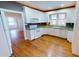 Well-lit kitchen with white appliances, light countertops, and hardwood floors at 1250 Lemon St, Punta Gorda, FL 33950