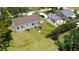 Aerial view of a home with a spacious yard, detached garage, and mature trees at 1250 Lemon St, Punta Gorda, FL 33950