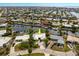 Aerial view of the property showcasing its manicured lawn, distinctive roof, and waterfront access at 155 Donna Ct, Punta Gorda, FL 33950