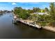 Waterfront property featuring a private dock with direct access to the canal and nearby amenities at 155 Donna Ct, Punta Gorda, FL 33950