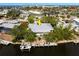 Aerial view of property featuring landscaping, waterfront location, dock, and proximity to the canal at 155 Donna Ct, Punta Gorda, FL 33950