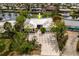 Aerial view of the home showcasing its driveway, landscaping, and unique roof design at 155 Donna Ct, Punta Gorda, FL 33950
