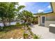 Beautiful backyard featuring a patio, lush landscaping, and waterfront views, creating a serene outdoor living space at 155 Donna Ct, Punta Gorda, FL 33950