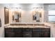 Modern bathroom featuring stylish mirrors, a granite countertop, and modern lighting at 155 Donna Ct, Punta Gorda, FL 33950