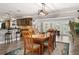 Open dining area features a wooden table, natural light, and easy access to the kitchen and outdoor area at 155 Donna Ct, Punta Gorda, FL 33950