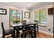Modern dining room featuring a dark wood table, bench seating, and bright windows at 155 Donna Ct, Punta Gorda, FL 33950