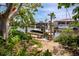 Waterfront property featuring a private boat dock with boat lift surrounded by lush landscaping on a sunny day at 155 Donna Ct, Punta Gorda, FL 33950