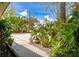 Paver driveway leading to lush tropical landscaping creating curb appeal and welcoming entry to the property at 155 Donna Ct, Punta Gorda, FL 33950