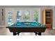 Well lit game room with a pool table, and doors leading to outdoor entertainment at 155 Donna Ct, Punta Gorda, FL 33950