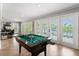 Game room featuring pool table and multiple french doors giving access to backyard views at 155 Donna Ct, Punta Gorda, FL 33950