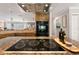 Gourmet kitchen featuring a cooktop island, stainless steel appliances, and custom range hood at 155 Donna Ct, Punta Gorda, FL 33950