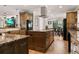 Gourmet kitchen boasts custom cabinetry, large island with cooktop and storage, and stainless steel appliances at 155 Donna Ct, Punta Gorda, FL 33950