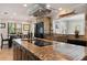 Beautiful kitchen with a large cooktop island, stainless steel appliances, and modern range hood at 155 Donna Ct, Punta Gorda, FL 33950