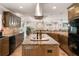 Gourmet kitchen featuring a cooktop island, stainless steel appliances, and custom cabinets at 155 Donna Ct, Punta Gorda, FL 33950